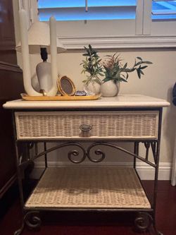 Wicker and metal queen sleigh bed and two night stands.