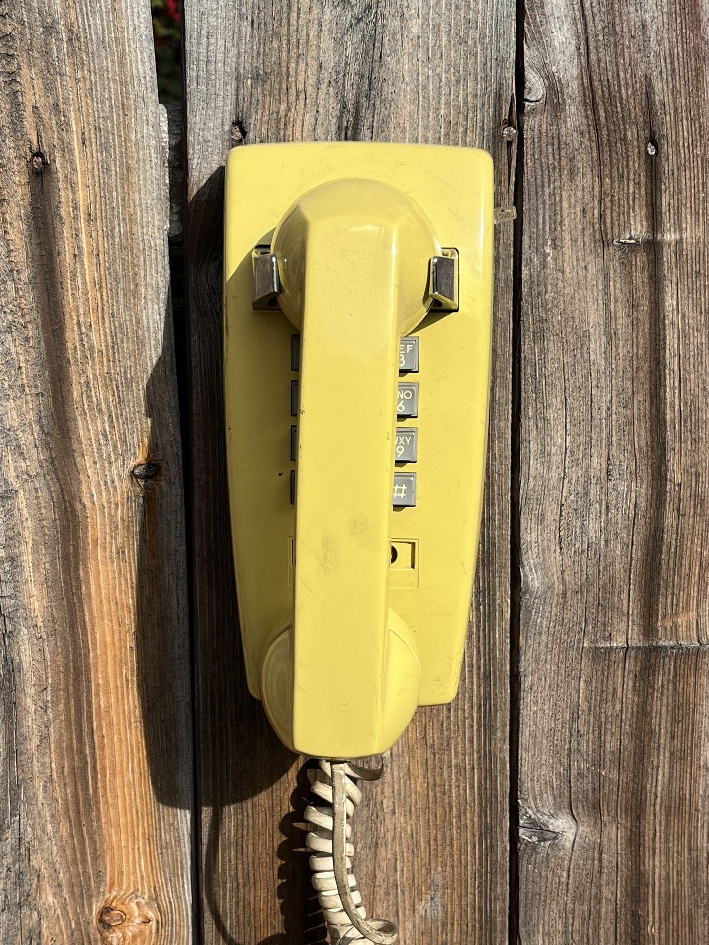 Title: Vintage Canary Yellow Wall-Mount Touch-Tone Phone Description: Bright 1970s Canary Yellow Pacific Bell touch-tone phone with 1980s retro style
