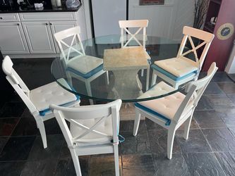 Round glass dining table with natural stone pedestal