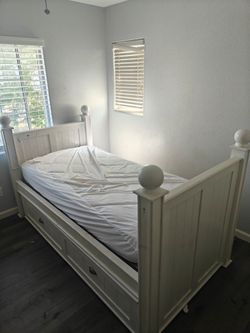 White wooden trundle bed