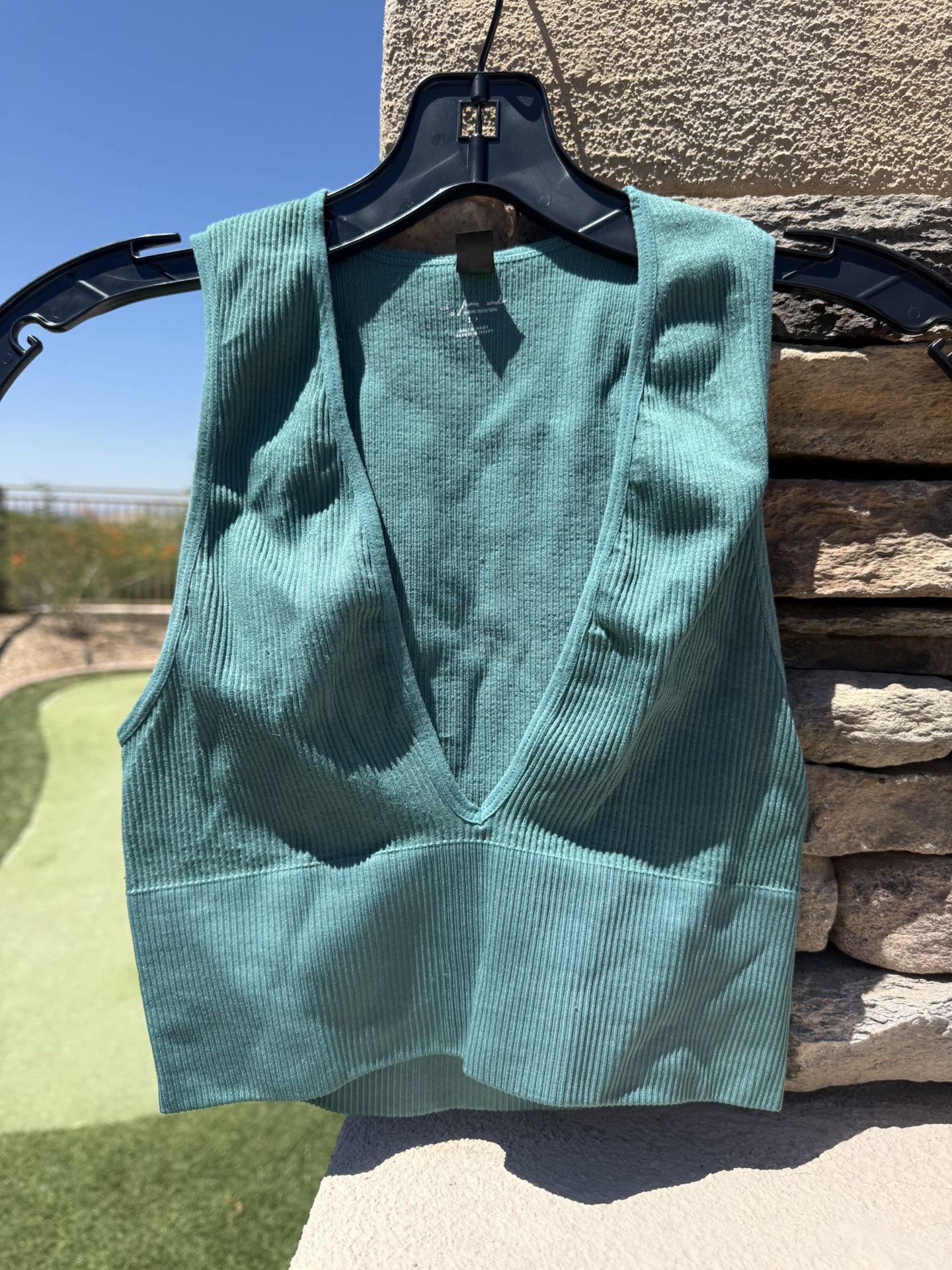 Green crop top women size small by urban outfitters Measurements Call in 14.5 inches in length and 11 inches across the chest, our pit to