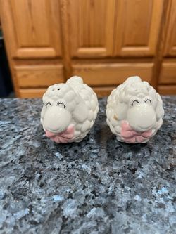 Vintage Ceramic White Sheep with Pink Bow Pair of Salt and Pepper Shakers.  Size approximately 2 1:2 inches tall and 3 inches long.  Preowned.