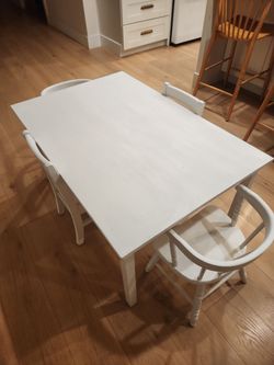 White kids table and 4 kids chairs.