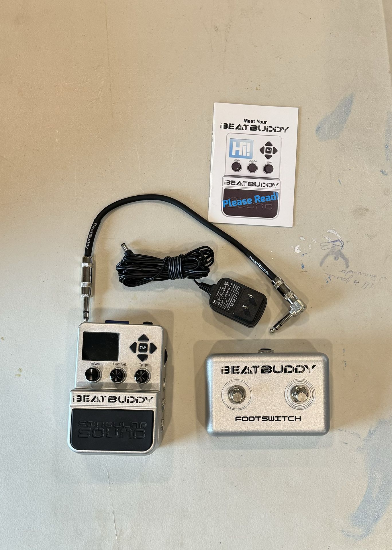 Singular Sound BeatBuddy with foot switch, connecting cable and power adapter.