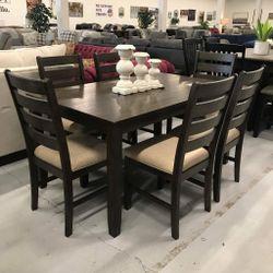 Brown Rectangle Dining Table set with cushioned chairs