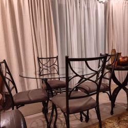 Beautiful Vintage Ashley Furniture Industries Inc Bevelled Round Glass Table With Iron Base And Four Beige/Taupe Cushion Iron ChairsI