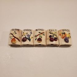 Five vintage ceramic shakers with a fruit design