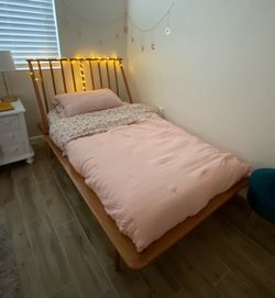 Wooden twin bed with mattress