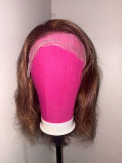 Wavy lace front wig. Brown hair with pretty highlights. Has a natural looking hairline. Medium length. 13x4 20 inch human hair willing to consider rea