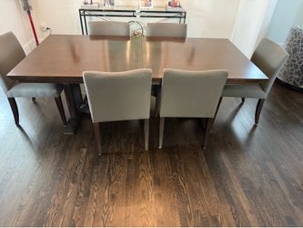 Solid wood table with 6 chairs. Has leaf extender