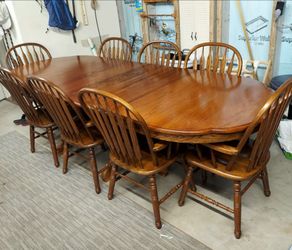 Oak dining room table and 8 Captain's chairs