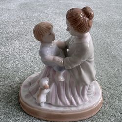 Vintage 1995 Avon “ her mother’s love” porcelain figurine, featuring a mother holding a child