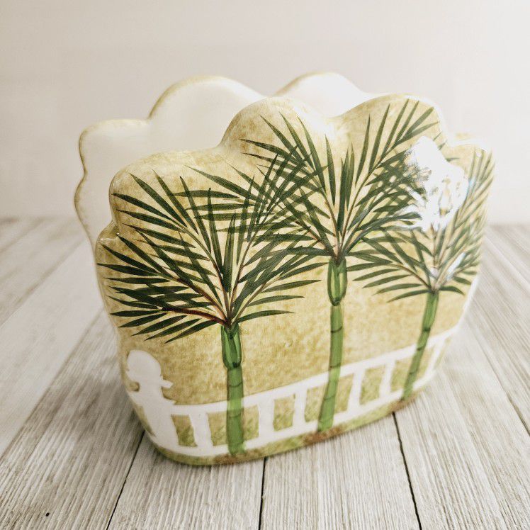 Palm Trees and White Fence Ceramic Decorative Napkin Holder Green Yellow White Home Decor. Measures 5"H x 5.75"L x 2.5"W.

Pre-owned in excellent clea