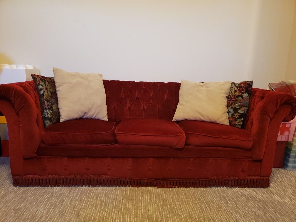Small red Chesterfield sofa / couch