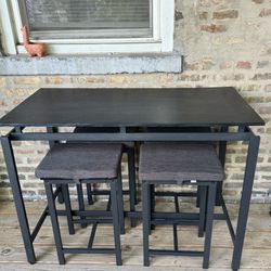 Black stool height table with 4 stools