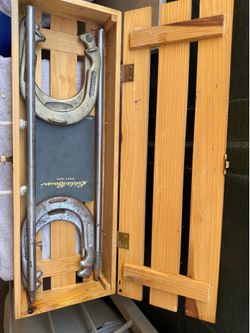 Eddie Bauer Horseshoe Set featuring forged steel shoes and stakes housed in a branded wooden carrying crate.
