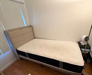 Beige bed frame and mattress