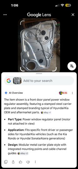 metal inner door panel assembly featuring a power window regulator mechanism, identifiable by the integrated Hyundai logo stamped on the steel plate.P