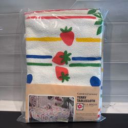 Vintage R A Briggs Garden Fantasy Terry Tablecloth new in pkg.  54”x90”  94% cotton / 6% poly Bright primary colors on white with different fruit deco