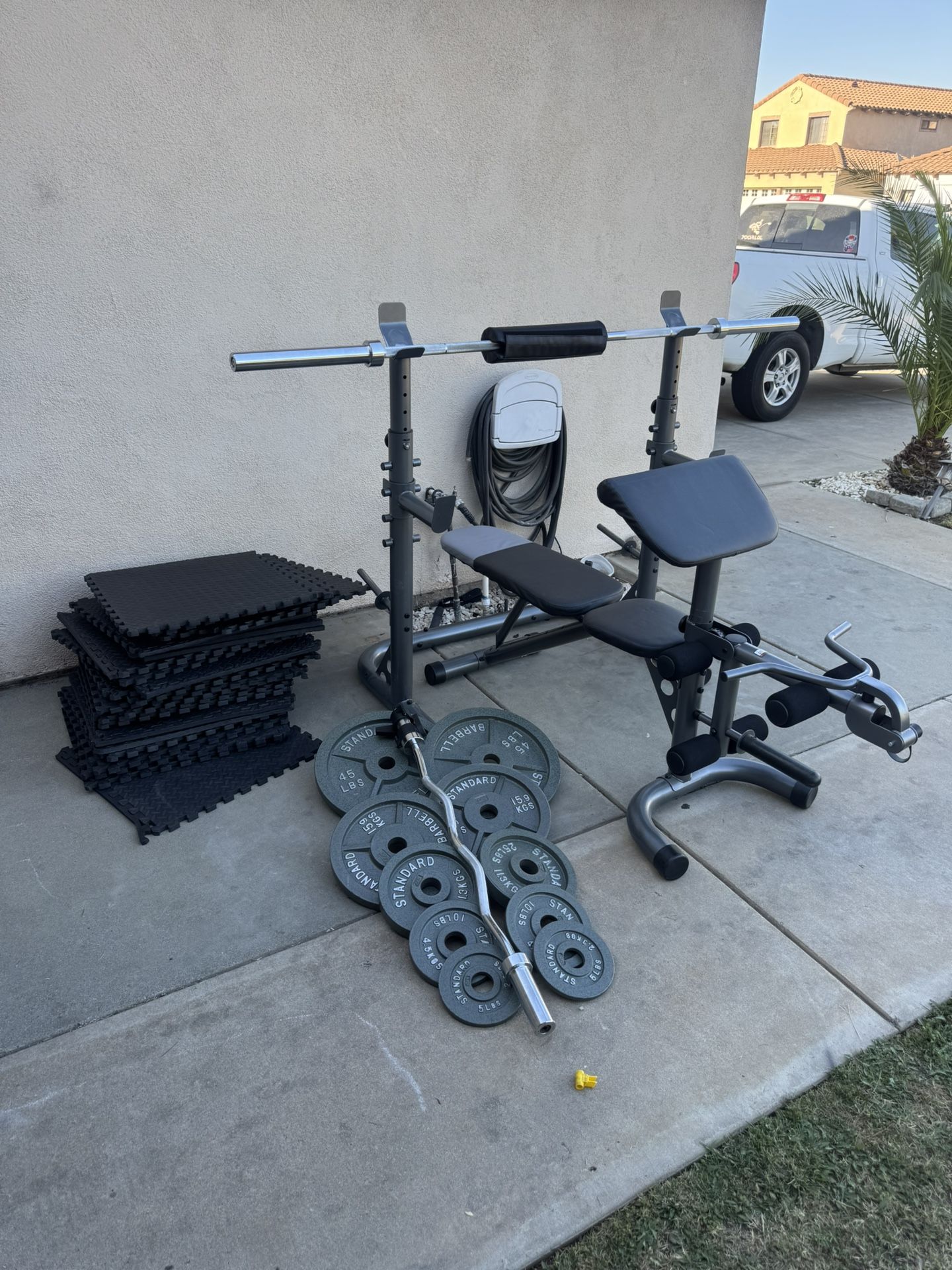 Bench press/squat rack with 7ft bar plus 240lbs weights plus curl bar and mats firm price