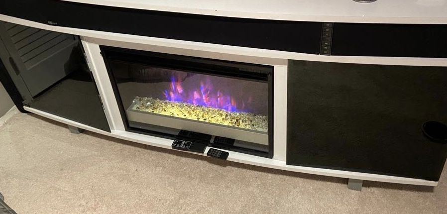 This TV stand has fire place with different looks . Electric heater and surrounding speakers you can connected to the TV. 2 Remote controls.