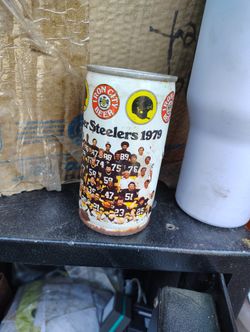 The image shows an Unopened vintage Iron City Beer can commemorating the 1979 Pittsburgh Steelers Super Bowl Championship team. 