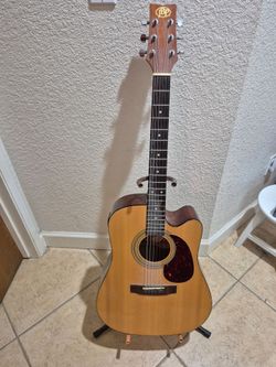 JB Player Acoustic Guitar. Spruce top and nato wood for the back, side and neck.