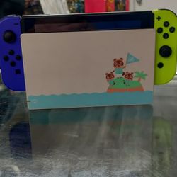 Nintendo Switch With Purple And Green Joycons With Animal Crossing Table And Dock