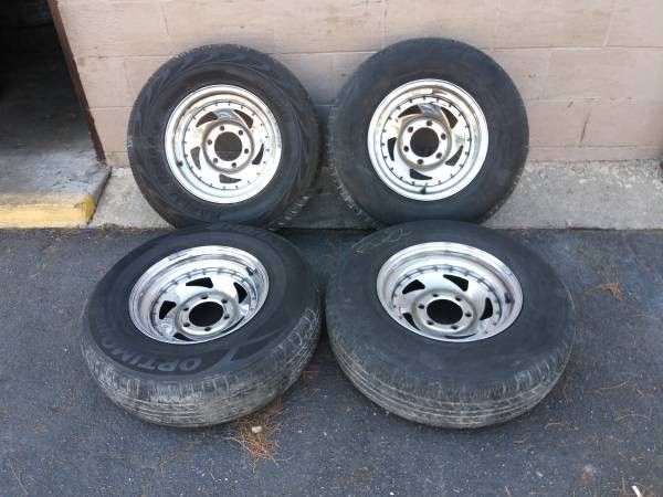 four chrome 15 inch sawblade rims with tires. 6 lugs, fits old trucks