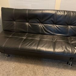 Black faux leather futon and matching ottoman