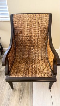 Large brown wicker chair with cushion
