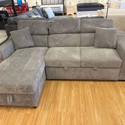 Brand new sleeper sectional with wireless charger, cup holder, pull out bed and reversible chase!