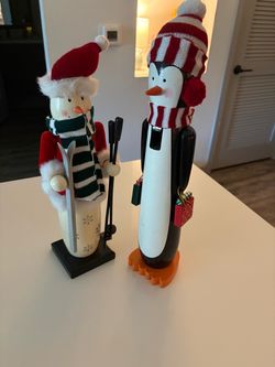 Holiday Inspirations Christmas figurine set featuring a tall penguin and winter skier figure.