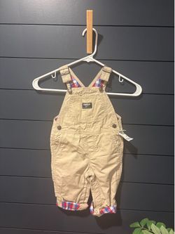 OshKosh B'gosh overalls feature a khaki canvas fabric with a plaid lining, 18-months