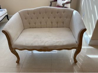 Vintage French Provincial loveseat featuring button-tufted upholstery