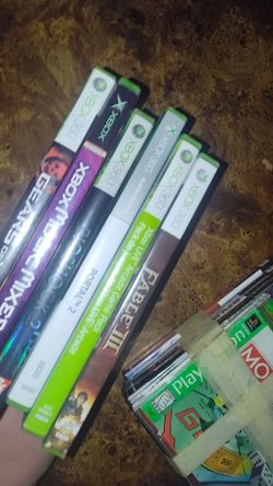 box of old gaming controllers,games and a sound bar
