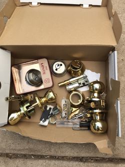 Two complete door knobs, and a box of spare parts
