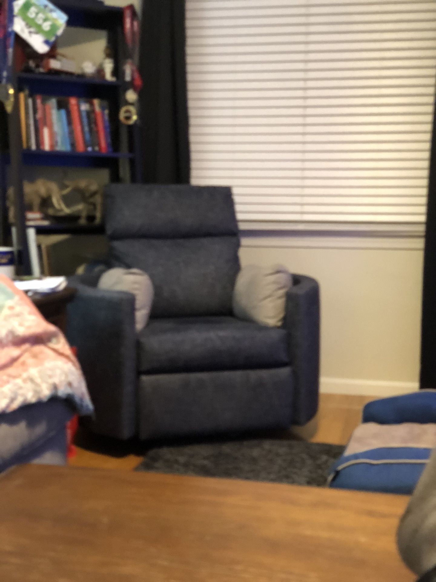 Jordan’s Furniture swiveling recliner chair. 