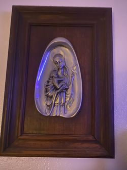 Madonna in pewter placed on wood