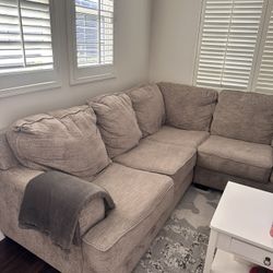 Gray 2 Piece Sectional Couch- No Too Much Wear. Does Not Have Pull Out Bed. 100 Inches On The Long Side , 90 On The “L” Portion.