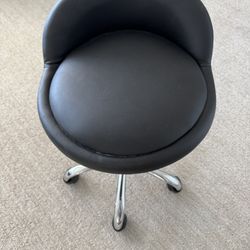 Leather and chrome swivel rolling stool