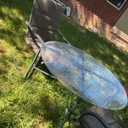 Two  Big , Strong  Patio Chairs In Good Condition , And A Glass Table 