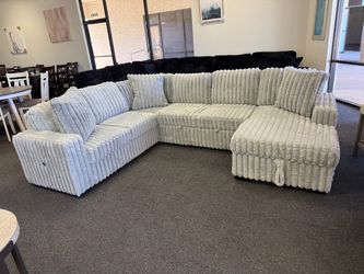 Sectional with sleeper and storage chaise