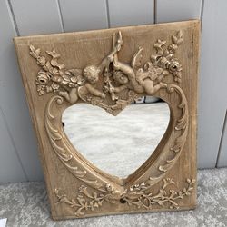 Heart shaped framed mirror with angels