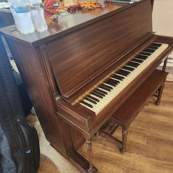 Classic wooden piano with bench