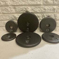 set of 6 cast iron weight plates for dumbbells 2 plates 5 lbs 2 plates 21/2 lbs 2 plates 11/4 los All 6 plates for $40