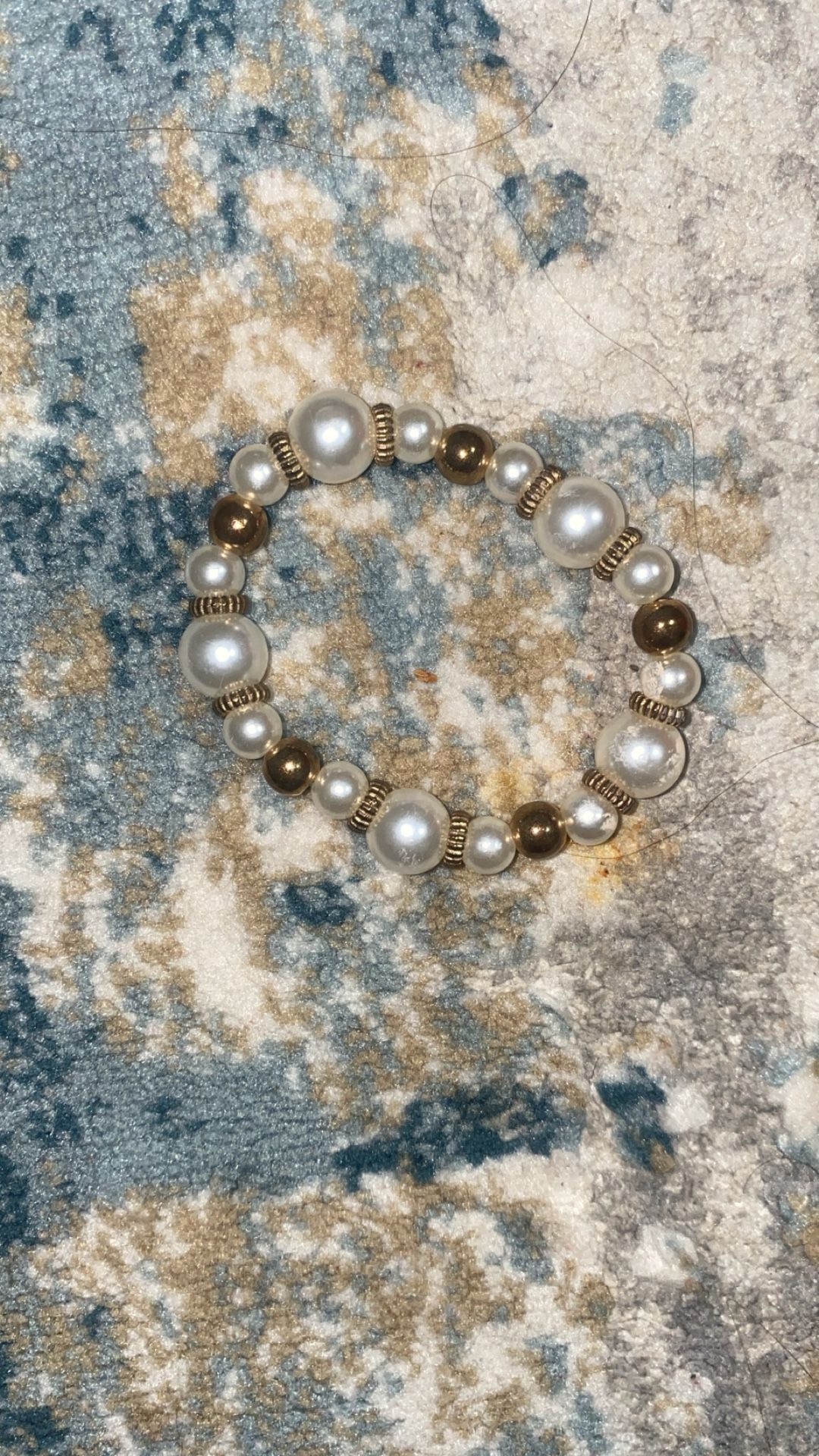 stretch bracelet featuring white pearls and gold corrugated beads.