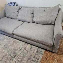 Grey Couch Filled With Down Feathers