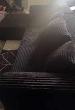 Black fluffy sectional , pillows included