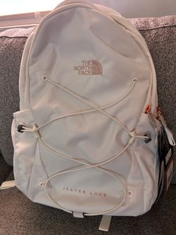 The North Face Jester Luxe Backpack in the White Dune/Burnt Coral Metallic colorway